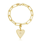 Gold bracelet with a heart-shaped charm on a white background