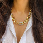Gold chain necklace worn by a person with long dark hair and a white shirt.

Pave CZ Two Tone Link Chunky Chain Necklace

Yellow Gold Plated
Links: 0.8" Long X 0.65" Wide
18-19.5" Long