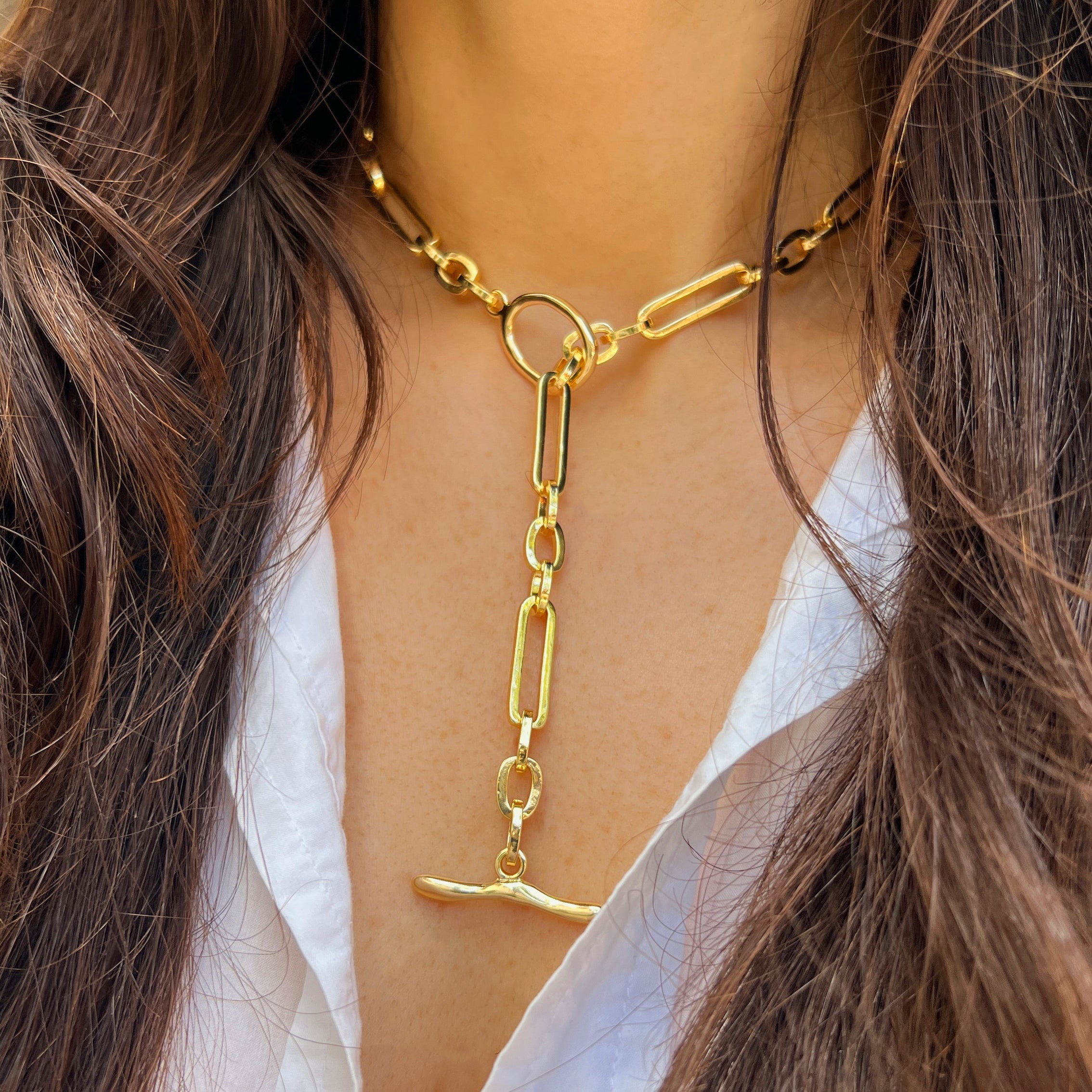 Gold chain necklace worn by a person with long hair and a white top.

Mixed Link Toggle Chain Necklace

Yellow Gold Plated
Large link: 0.83" Long X 0.24" Wide
Small Circle link: 0.36" Long X 0.25" Wide
16" Long