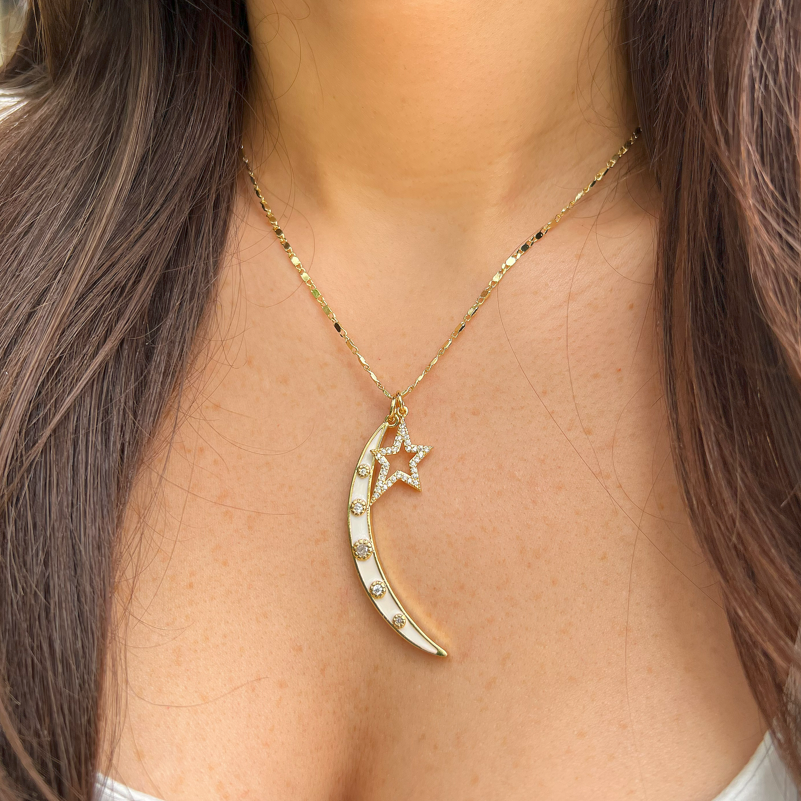 CZ Enamel Moon &amp; Star Charm Necklace

Yellow Gold Plated
Moon: 2" Long X 0.25" Wide
Star: 0.75" Long X 0.5" Wide
17-19" Adjustable Length

While supplies last. All Deals Of The Day sales are FINAL SALE.