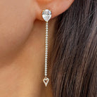 Cubic Zirconia Heart drop earring worn on an ear.