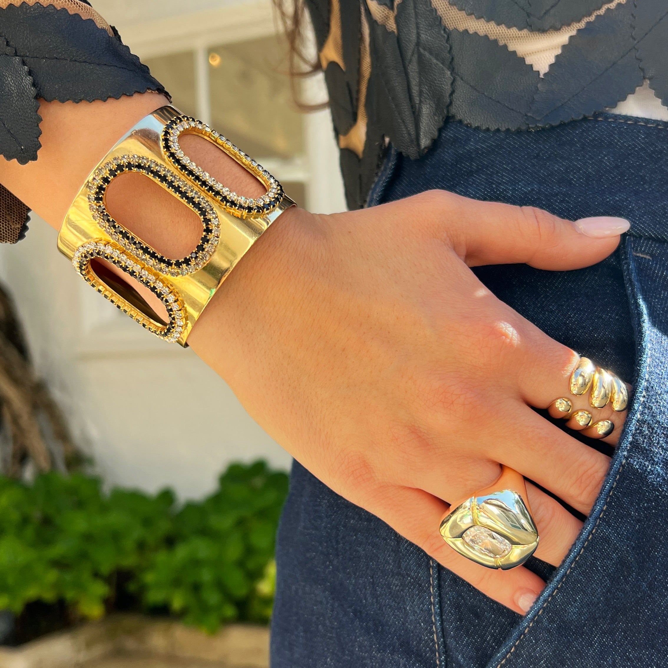 Black &amp; Clear Oval Cutout Cuff Bracelet

Yellow Gold Plated
1.94" Wide