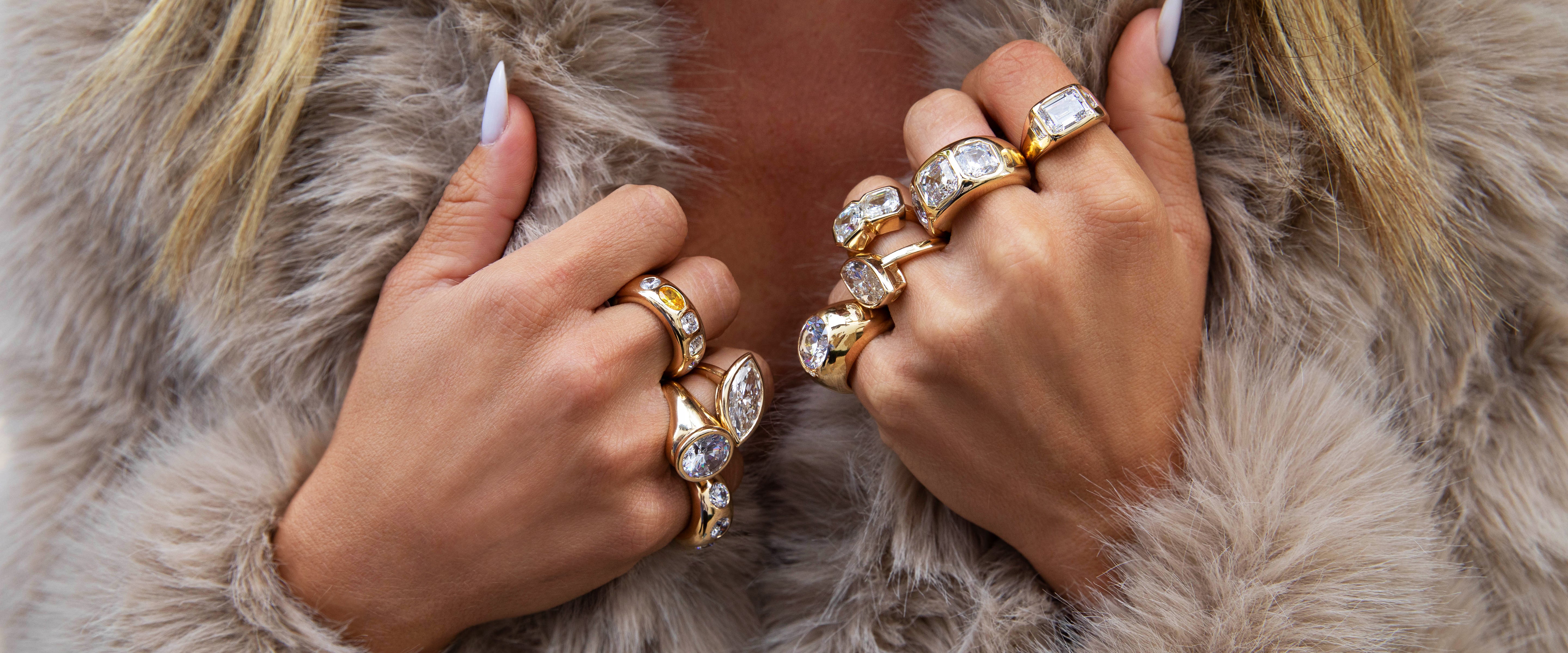 Close-up of hands wearing gold rings 