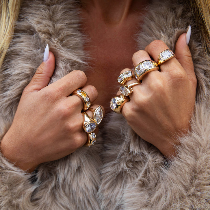 Close-up of hands wearing gold rings 