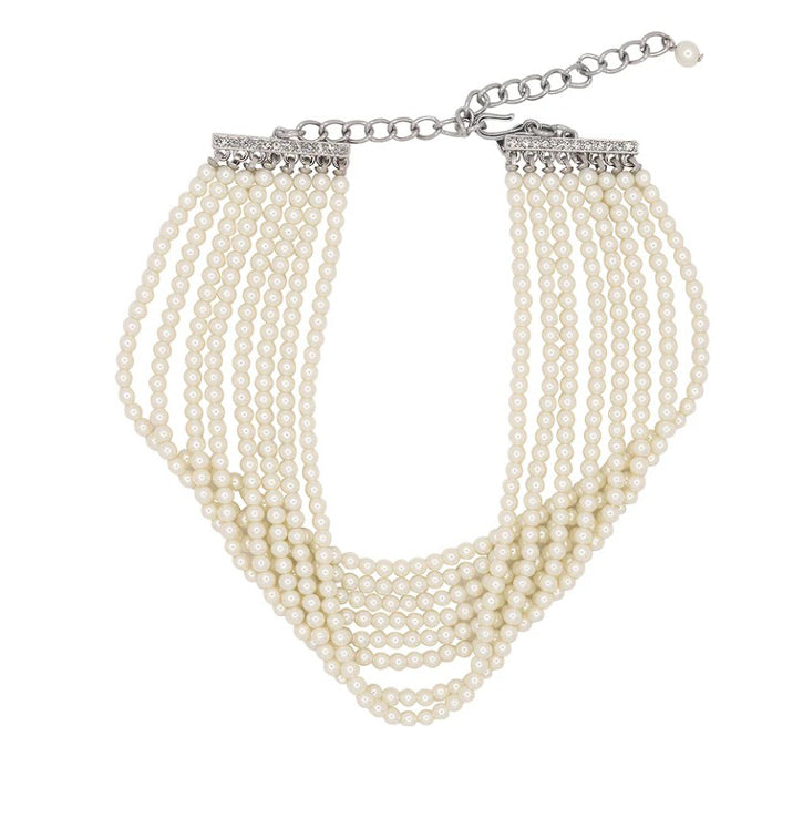 Multi-layered pearl bracelet with a silver crystal clasp on a white background