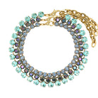 Multicolored gemstone necklace with gold chain on a white background