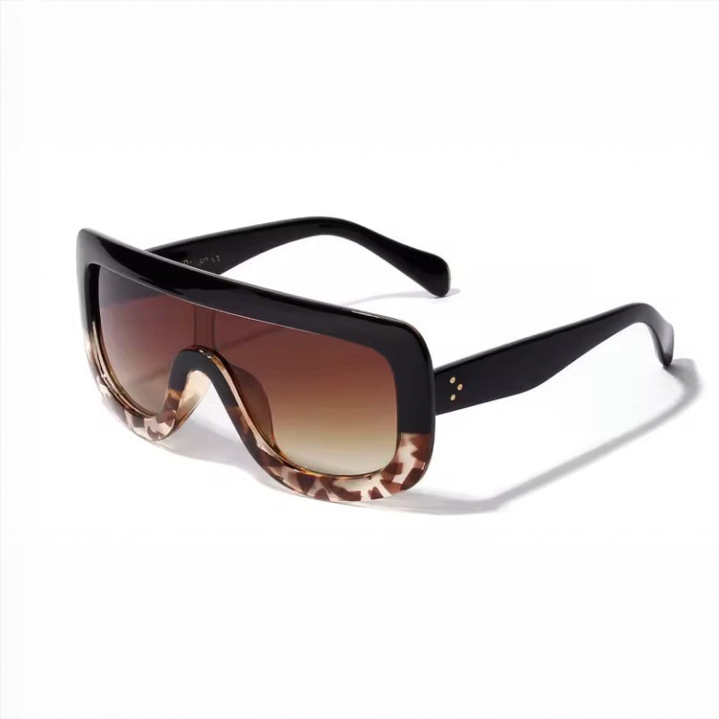 Sunglasses with gradient brown lenses and black frame on a white background