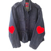 Denim Ruffled Heart Detail Jacket  Looking for a denim jacket that will show off your playful side? Look no further than our Denim Ruffled Jacket! Featuring a cute heart detail, this statement jacket is the perfect addition to any outfit.&nbsp;  Red Hearts On Elbows One Size   Designed by Romi Basha.  Due to popular demand, please allow 2-3 weeks for delivery.