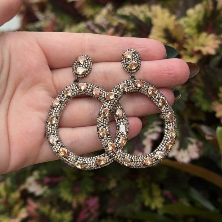 Champagne Stone Open Circle Pierced Earrings

Oxidized Plated Over Silver
2.50" Long X 1.75" Wide