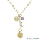 A gold-toned necklace with multiple charms, including a sunburst, a lavender square stone, a crescent moon, and a four-leaf clover, shown on a white background with To-Benefit Women's Alzheimer's Movement and Cleveland Clinic logos at the bottom right.