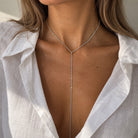 Tennis Lariat Necklace

Classic tennis lariat with a delicate sparkle, finished in yellow gold plating. The adjustable bolo tie lets you customize the length for an effortless, elegant look. Wear it solo for a sleek statement or layer it with your favorite chains.

Yellow Gold Plated

13.75'' Drop
12.5"- 15.5" Adjustable Bolo Tie&nbsp;