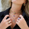 Diamond & lapis heart necklace worn with yellow gold and lapis chain link necklaces and rings