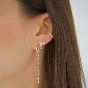 Diamond link huggies worn with yellow gold and pave chain link cuff and drop earrings