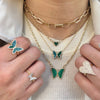 Malachite and diamond collection featuring necklaces and rings on model