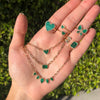 Emerald, malachite, and diamond jewelry on hand.