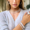 Faux diamond jewelry collection on woman.