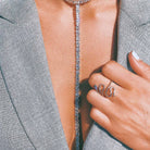 Woman wearing baguette lariat necklace with white gold snake ring