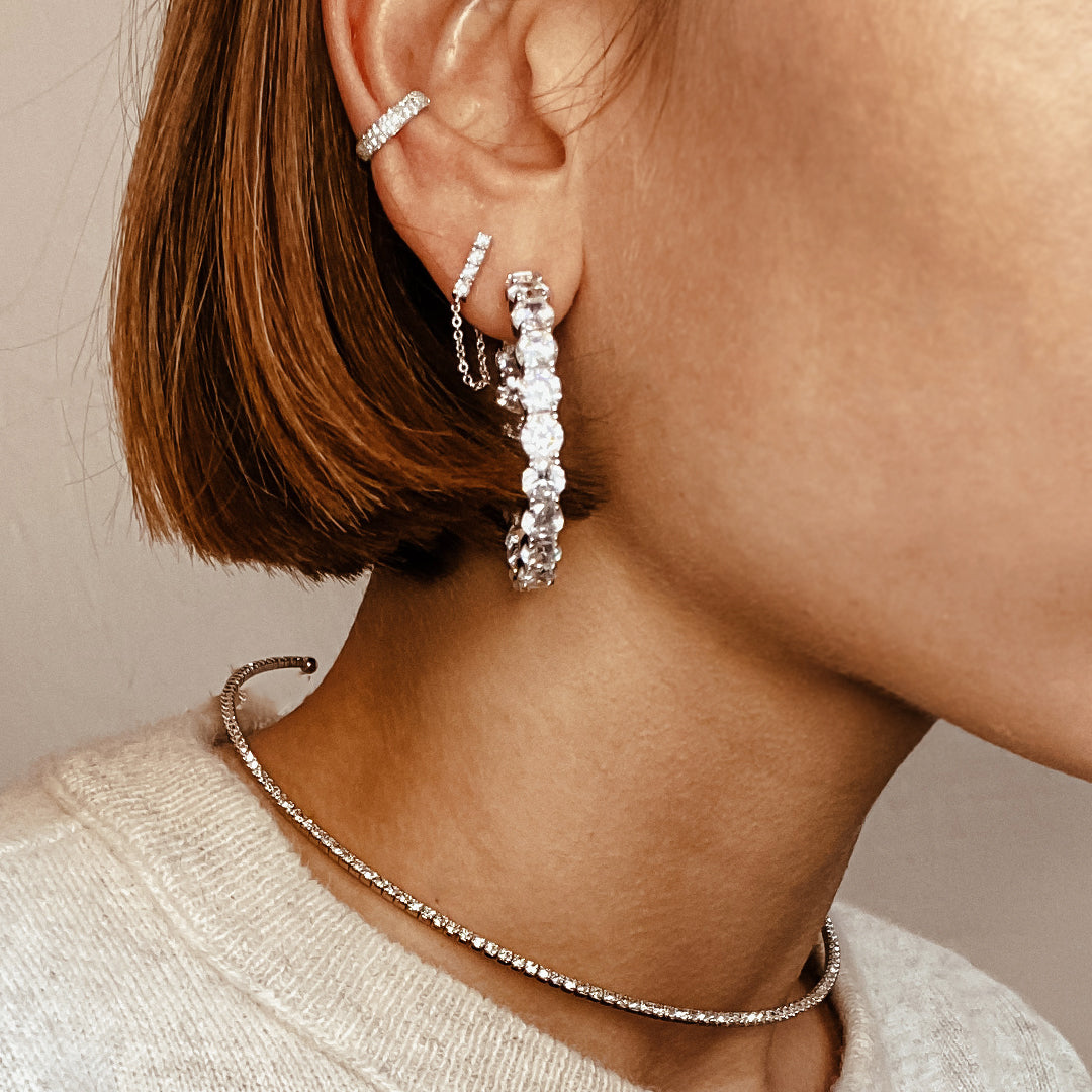 White gold hoop ear party on a woman's ear.