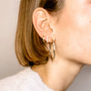 Woman wearing 14k Gold Hoops with yellow gold and pave huggies