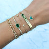 Diamond & malachite heart bracelet worn stacked with delicate yellow gold chain link bracelets