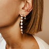 Woman wearing diamond ear cuff with large pave circle hoops and diamond drop earrings