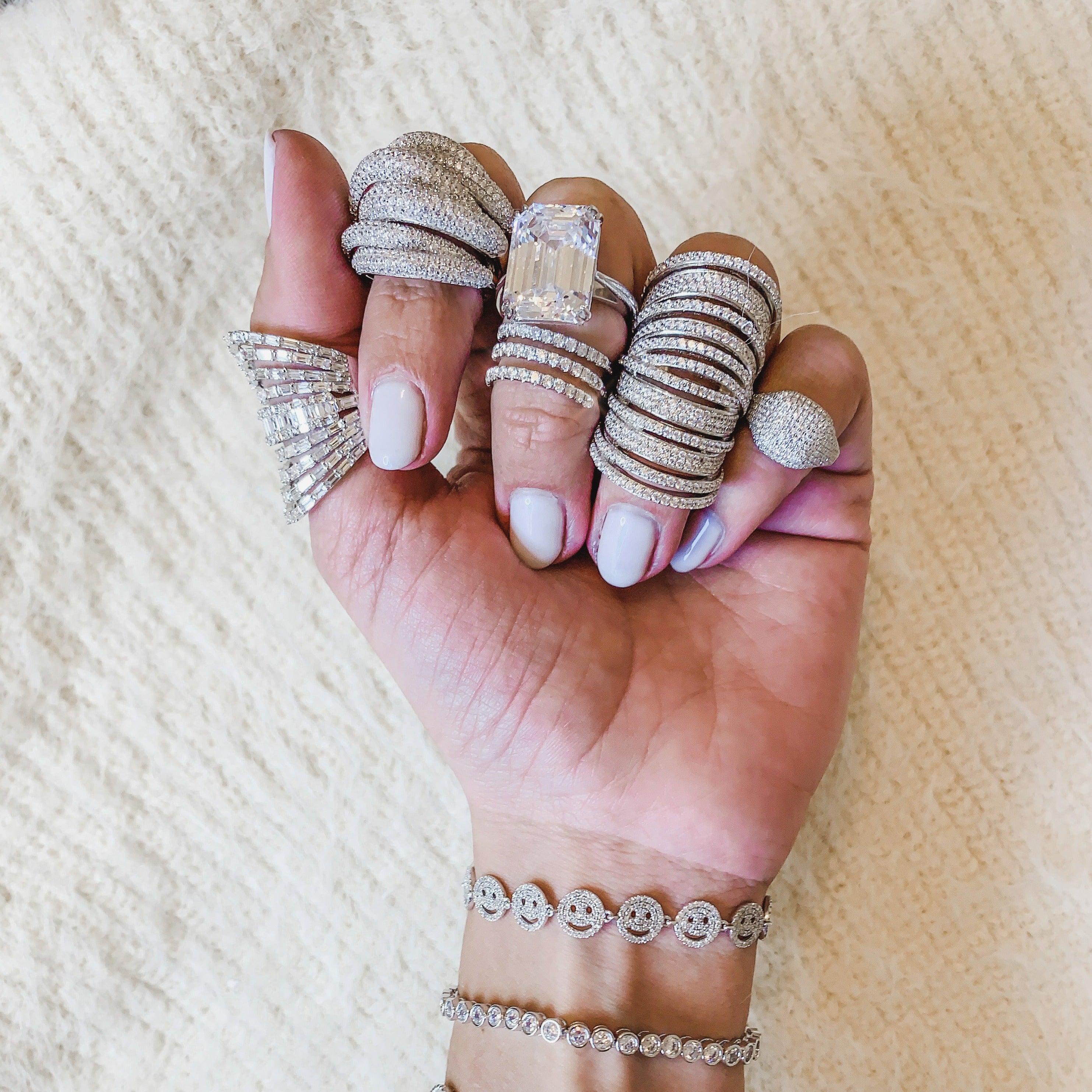 Pave multi band ring displayed on fingers with other pave white gold rings