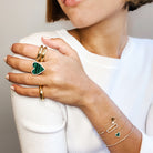 Diamond & malachite heart bracelet worn with yellow gold thin bracelets and large chunky rings