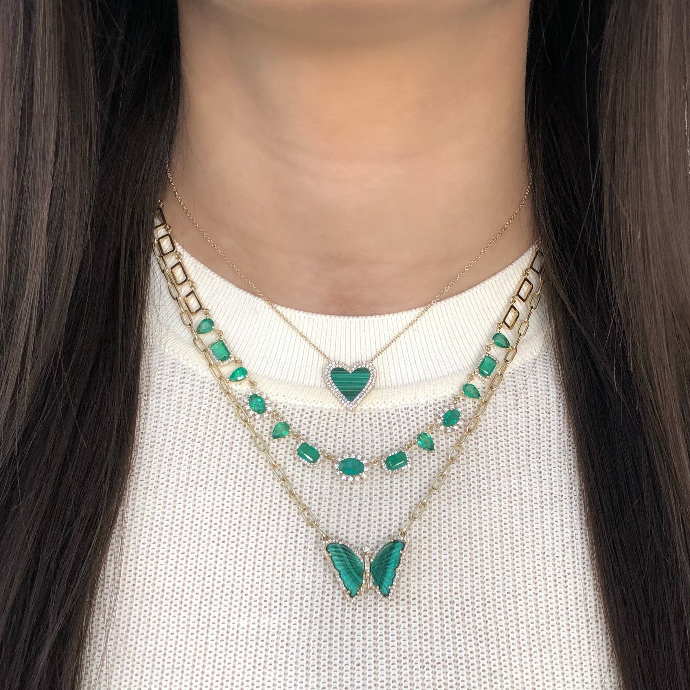 14K Gold Emerald & Diamond Necklace  14K Yellow Gold 0.53 Diamond Carat Weight 5.84 Emerald Carat Weight Chain: 15.5" Length Widest Stone: 0.30" Diameter