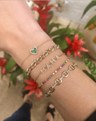 Diamond & malachite heart bracelet worn stacked with delicate yellow gold chain link bracelets