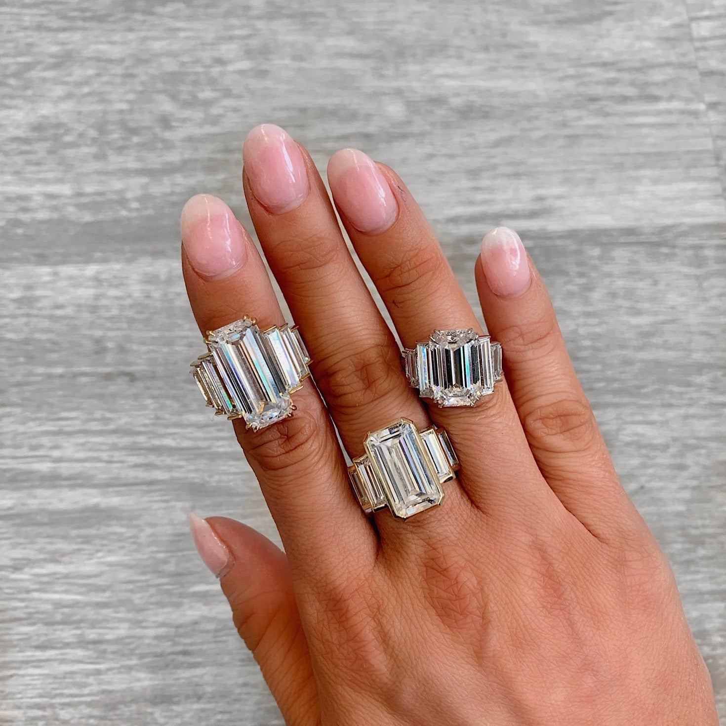 Three chunky CZ rings on a finger.
