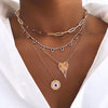 Link chain necklace modelled with layered pave and sapphire necklaces