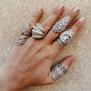 Woman wearing leaf ring with white gold pave ring collection