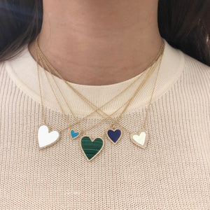 Pave Diamond Outline & Malachite Heart Chain Necklace  14K Yellow Gold 3.55 Malachite Carat Weight 0.18 Diamond Carat Weight Chain: 15-17" Length Heart: 0.80" Length W X 0.75" Width Heart pendant available in pearl, lapis, and turquoise in a variety of sizes
