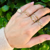 Diamond nail ring on woman's hand paired with others from yellow gold chain link ring collection
