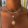 Diamond heart disc necklace layered with shorter yellow gold and pave necklaces