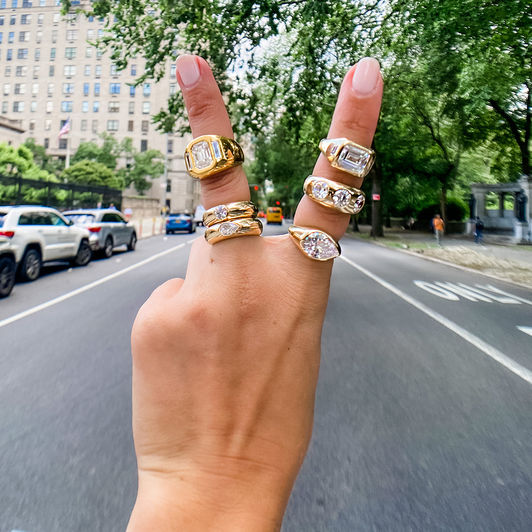 Gypsy ring collection on woman's hand with city background