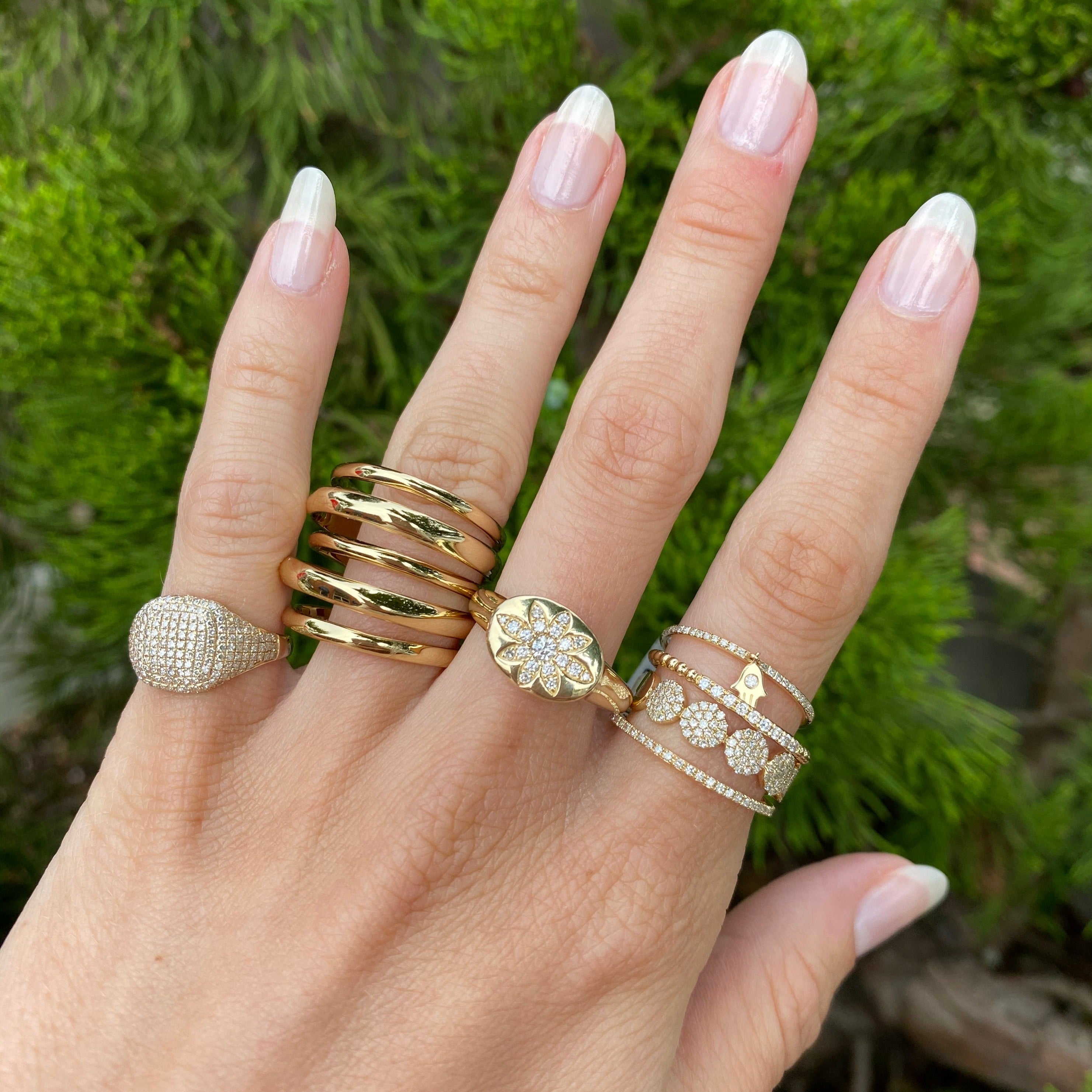 Diamond pinky ring worn with other yellow gold and statement diamond pave rings