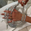 hand holding Silver Shiny Twisted Mesh Tassel Hobo Bag
