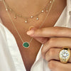 Round gypsy ring worn with emerald necklace and diamond choker