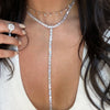 Woman wearing dangle choker with diamond baguette lariat necklace