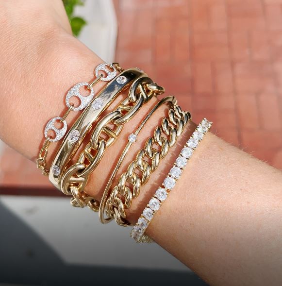 wrist with stacked bracelets