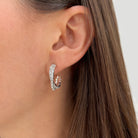 White gold bypass hoop earring on woman's ear