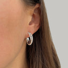 White gold bypass hoop earring on woman's ear