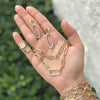 Yellow gold link collection in various styles on a hand