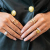 Model wearing yellow and white gold rings.