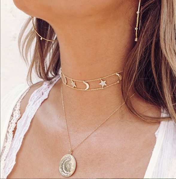 Bezel hoop earrings paired with yellow gold charm necklace and chokers