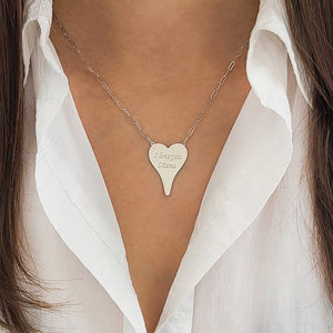 Close up of sterling silver heart necklace on woman, engrave with "I love you Mama"