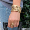Multi stone bracelet stacked with yellow gold + stone bangle bracelets
