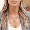 Diamond choker necklace worn atop layered yellow gold pave necklaces