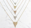 Pave diamond necklaces in rose, white, and yellow gold; and small, medium, and large sizes against a marbled background